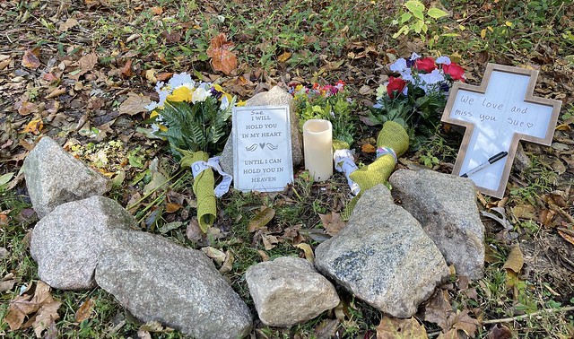 A somber memorial marks location on the Raleigh, NC Neuse River Greenway, where a gunman shot and killed 2 people.  He killed a total of 5 people and wounded two for a total of 7 victims.  The alleged shooter is 15.
