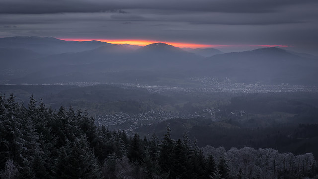 Bright red sunset behind a mountain ridge in the Murg Valley in the German Black Forest