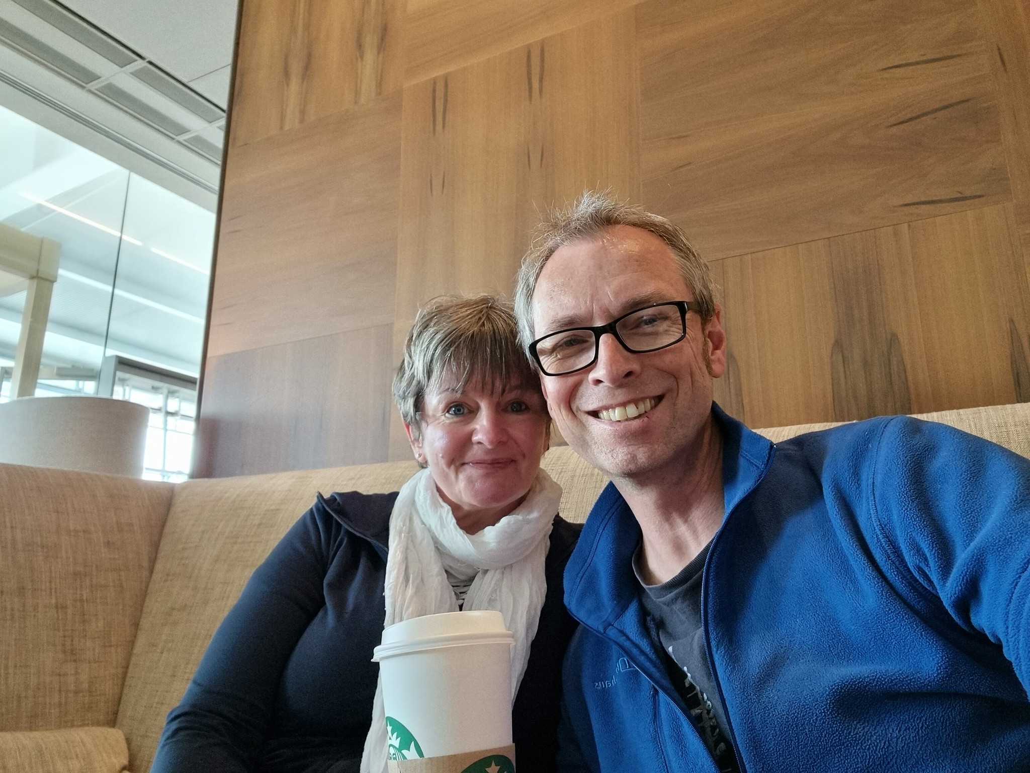 Vick and I enjoying our Starbucks in the CCR at Heathrow T5