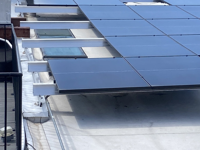 Close Up Solar PV Installation On Roof Top Of Townhouse