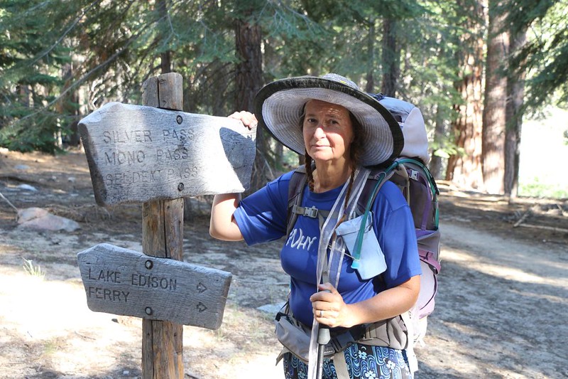 A very tired Vicki posing next to the trail to Lake Edison and VVR, on the John Muir Trail near Mono Creek