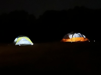 Tents at Night with Lights on in the Tents