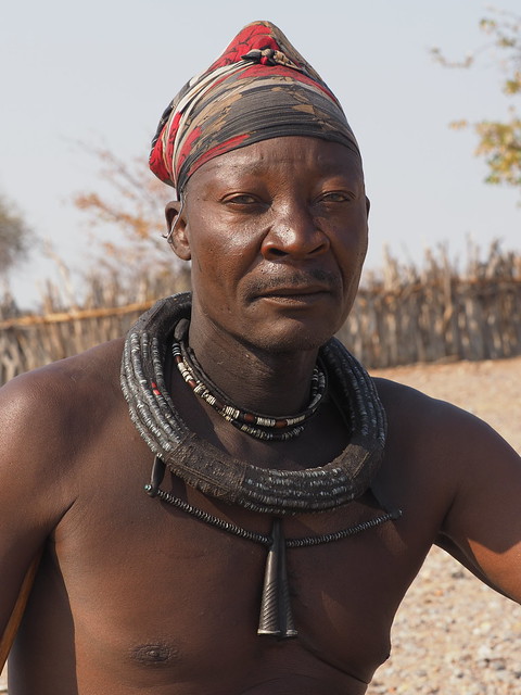Married Himba men wear a head-wrap and un-braided hair beneath. Men do not apply Otjize on their skin