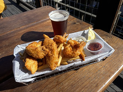Fried rock cod and prawns with fires and a beer