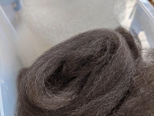 A twisted length of handcombed black Alpaca by irieknit.  Alpaca is grown by Stone Spindle Farm in Tamworth Ontario.