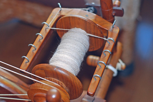 Handspun alpaca by irieknit on Watson Martha spinning wheel in butternut wood.  Detail of yarn that has wound onto the wheel's bobbin and is guided by the two hooks at the spinner's side of the wheel.