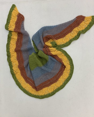 These two shawls are Mary Jane’s Ka’ana Shawlette by Jennifer Weissman both knit with the same colour changing yarn. She knit one starting from the centre and one starting from the outside.