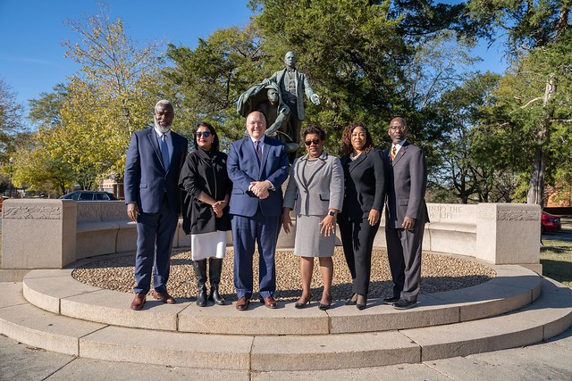 A group of leaders stand outside at Tuskegee University