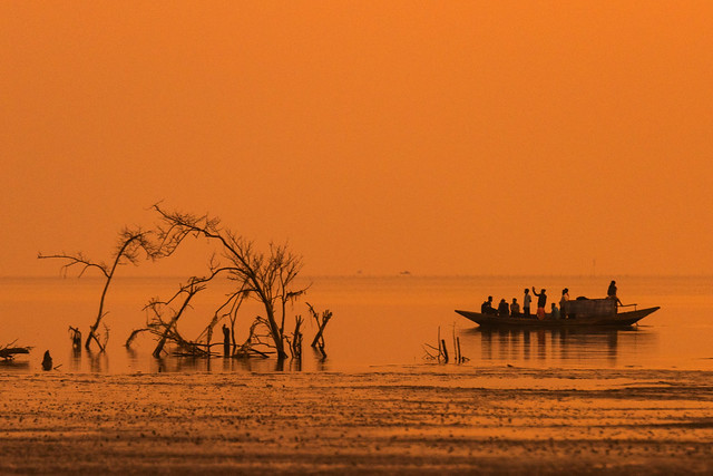 People returning home after work during sunset from different areas on Tarua beach at Bhola, Barishal District in south west Bangladesh.