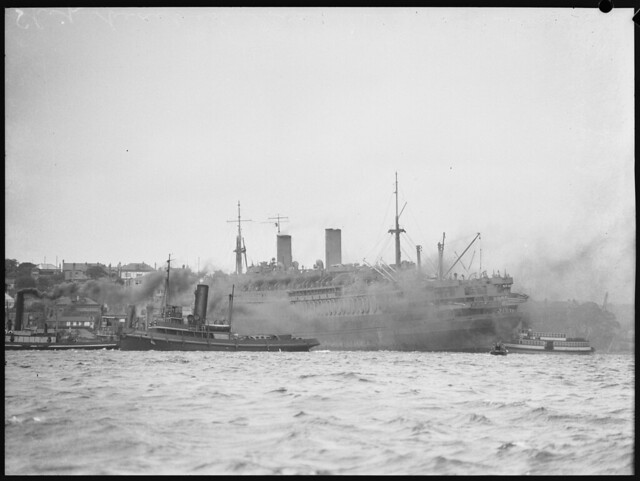 Ship surrounded by tug boats, Balmain, 1942