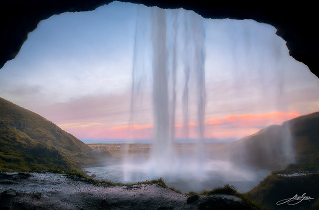 Behind the waterfall at Seljalandsfoss at sunrise, Iceland. November 2022