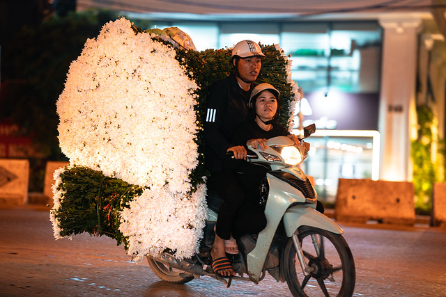 Man & Woman on Motorcycle With Load of White Flowers, Hanoi Vietnam
