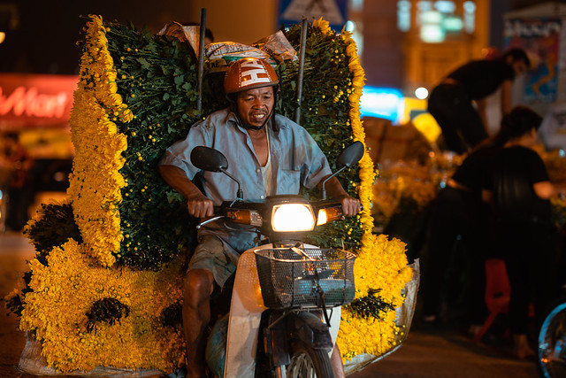 Man Arriving At Flower Market with Yellow Flowers on Motorcycle, Hanoi Vietnam