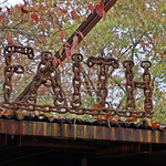 Robert Wells Chain Sculptures and Roadside Ministry and Environment. &amp;quot;By day Robert Wells (1949-2012) safely removes dangerous asbestos from construction, demolition and renovation sites; but nights and weekends he creates art objects of welded chains, railroad spikes and you-name-its. This is Robert Wells and that is some of his art, which you will see if you will but look east as you travel along highway 71 through Grannis. That&#039;s about midway between DeQueen and Mena.

His most recent and most ambitious works are acts of religious devotion.modular metal prayer tablet At right is the piece that lured me off the highway. It&#039;s a giant prayer tablet that holds words made of welded chain (raw material which costs about a buck a link). It reads, &amp;quot;FINISHED... THE SEED OF HOPE IT IS... PARTNERS IN PRAYER JESUS NAME WE WISH AND PRAY GOD&#039;S WILL IN YOUR LIVES T FIRE 2000 IN THE FORM OF HEALING MIRACLES AND BLESSINGS AMEN THANK YOU JESUS IOU.&amp;quot;

The welded link fragments, he told me, represent the chains of spiritual bondage which had been broken with the help of Jesus.welded log chain wellhouse I&#039;m paraphrasing a bit, but I think that&#039;s the gist of it. The construction is modular so the tablet can be expanded or contracted line by line and the words can be changed as the situation requires. Robert told me that the prayers used to be written with individual letters, but now he welds them together in complete words. He didn&#039;t say so, but I&#039;d bet a week&#039;s pay that he had trouble with the local hooligans rearranging the prayers into obscenities. Also notice the map of Arkansas in the upper quadrant of the tablet. The radiating figure marks Grannis on the map.

If your taste in art is more secular, here is a log chain wishing well you might like. In and around his shop he has a five-foot globe on gimbals, six-foot spatula and frying pan set, welded footbridges and numerous park benches and planters.&amp;quot;

Text by: &lt;a href=&quot;http://arkansasroadstories.com/wells.html&quot; rel=&quot;noreferrer nofollow&quot;&gt;arkansasroadstories.com/wells.html&lt;/a&gt;

Featured on PBS Rare Visions and Roadside Revelation &lt;a href=&quot;https://www.pbs.org/video/mena-arkansas-to-port-arthur-texas-qa5lqh/&quot; rel=&quot;noreferrer nofollow&quot;&gt;www.pbs.org/video/mena-arkansas-to-port-arthur-texas-qa5lqh/&lt;/a&gt;

See also: &lt;a href=&quot;https://www.roadsideamerica.com/tip/49511&quot; rel=&quot;noreferrer nofollow&quot;&gt;www.roadsideamerica.com/tip/49511&lt;/a&gt;