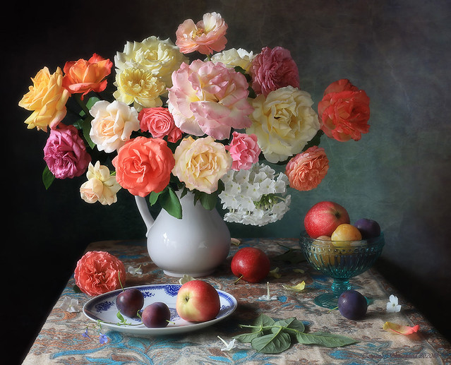 Still life with garden roses and summer fruits