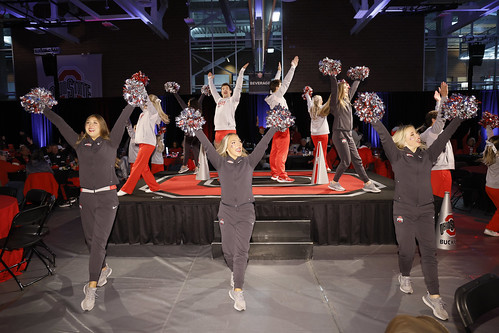 The Ohio State Cheerleaders performing on stage at the Pregame Huddle