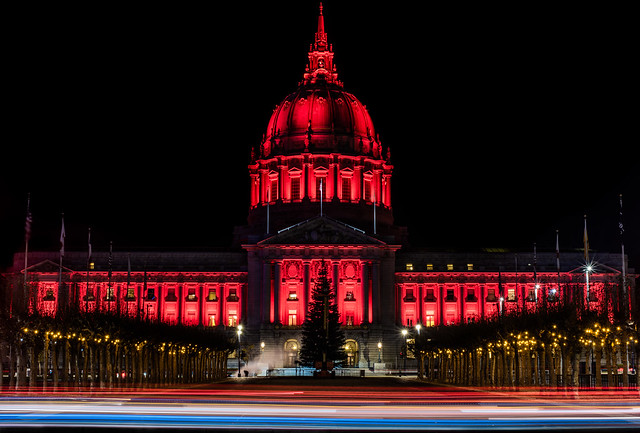 city hall illuminated red for world aids day