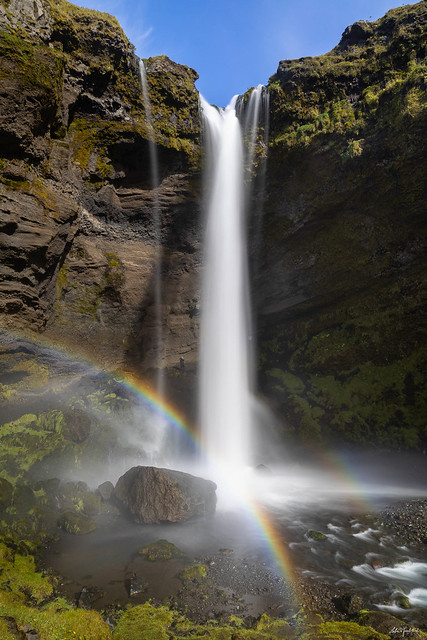 A magical waterfall decorated with a rainbow