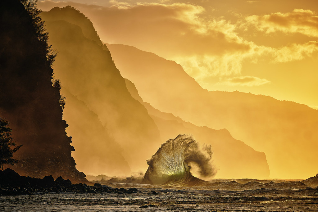 A back lit wave flare in front of the Na'Pali Coast, Kauai.