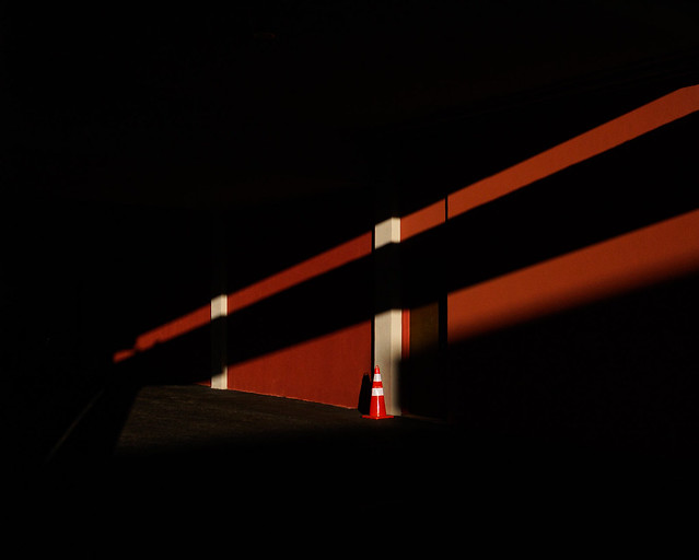 light, shadow, and a traffic cone