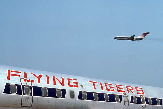 1976. A Flying Tigers DC-8 at Shannon Airport, beneath a departing British Airways VC10