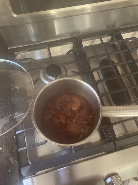 pot on stove with orange onion skins dye