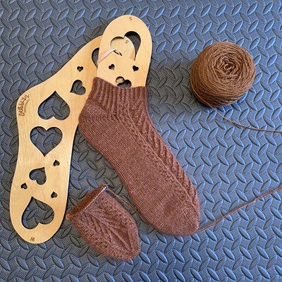 I am back to working on my Lonely Forest Socks by Caitlin Hunter! My finished first sock is  shown on a Dubblzz Hearts Sock Blockers by Burning Impressions of BC!