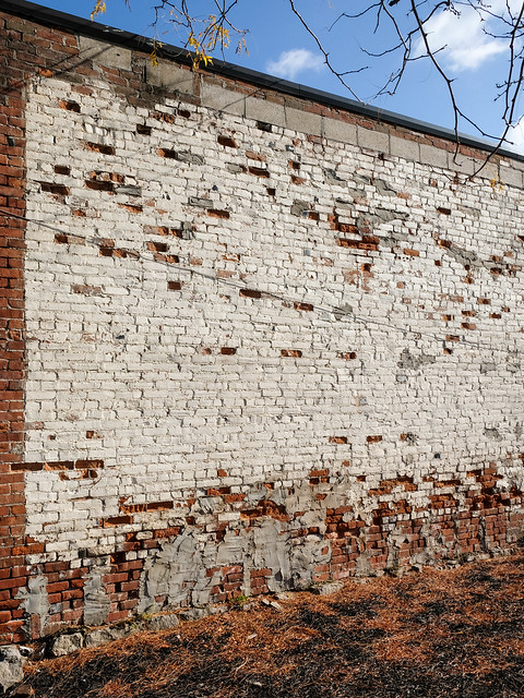 I found a deteriorating brick wall!, with numerous missing bricks, and trowel-smeared mortar.