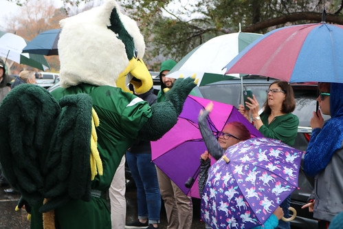 The W&M Griffin greets the crowd as they send off the Tribe football team on a rainy day in Wiliamsburg.