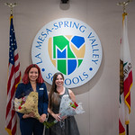 Brianna Coston and Caitlin Tiffany, La Mesa Spring Valley School District Trustee La Mesa Spring Valley School District Trustees Brianna Coston and Caitlin Tiffany with flowers in front of the district logo, US flag, and California flag after being sworn in.