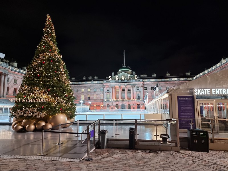 The ice rink at Somerset night, seen by night, with nobody else around. There is a large Christmas tree on the right, with Moet 7 Chandon written on it