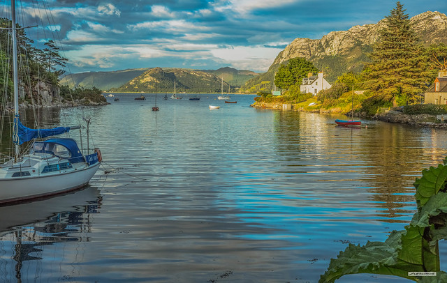 A Plockton Bay at sunset in summer, a peaceful, calm mooring for the boating fraternity, Wester Ross, Scotland.