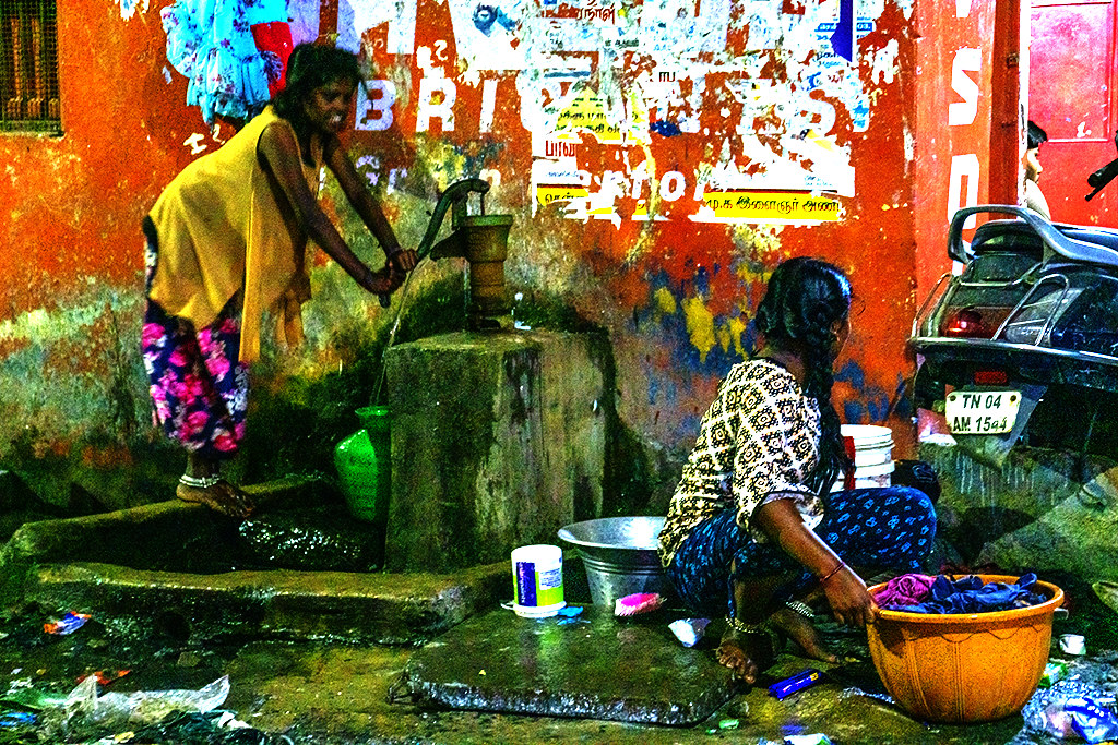 Girl pumping water and woman doing laundry at Karpura and VV Koil on 12-21-22--Chennai copy