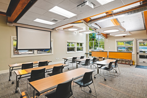 Meeting room with tables, chairs & projector screen