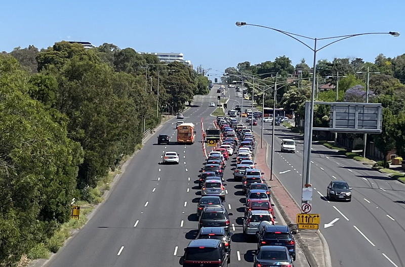 A bus slows to merge into a priority turning lane into Chadstone, Boxing Day 2022