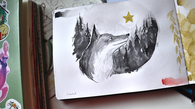 Aquarelle d'un renard en noir et blanc regardant une étoile dorée