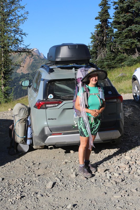 Vicki wearing her backpack next to the car as we get ready to start hiking north to Canada on the PCT at Slate Peak
