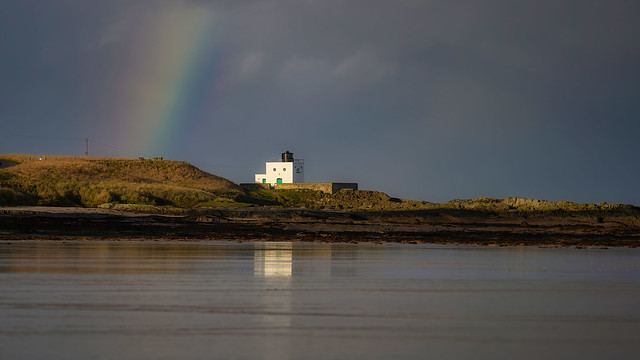 The lightouse the reflection and the rainbow