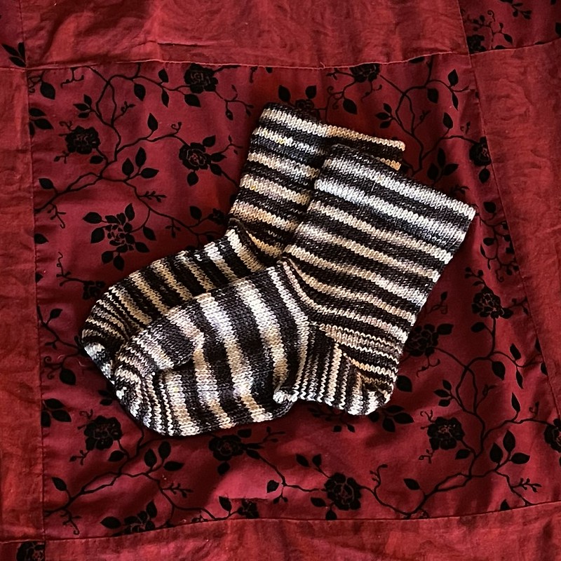 black and white striped socks that were knitted on a circular sock knitting machine