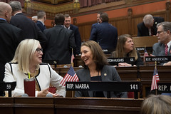 State Representative Tracy Marra shares a laugh with Rep. Hall during the opening day of the 2023 legislative session in the House of Representatives.