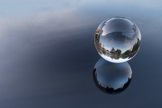 Glass ball on glass surface