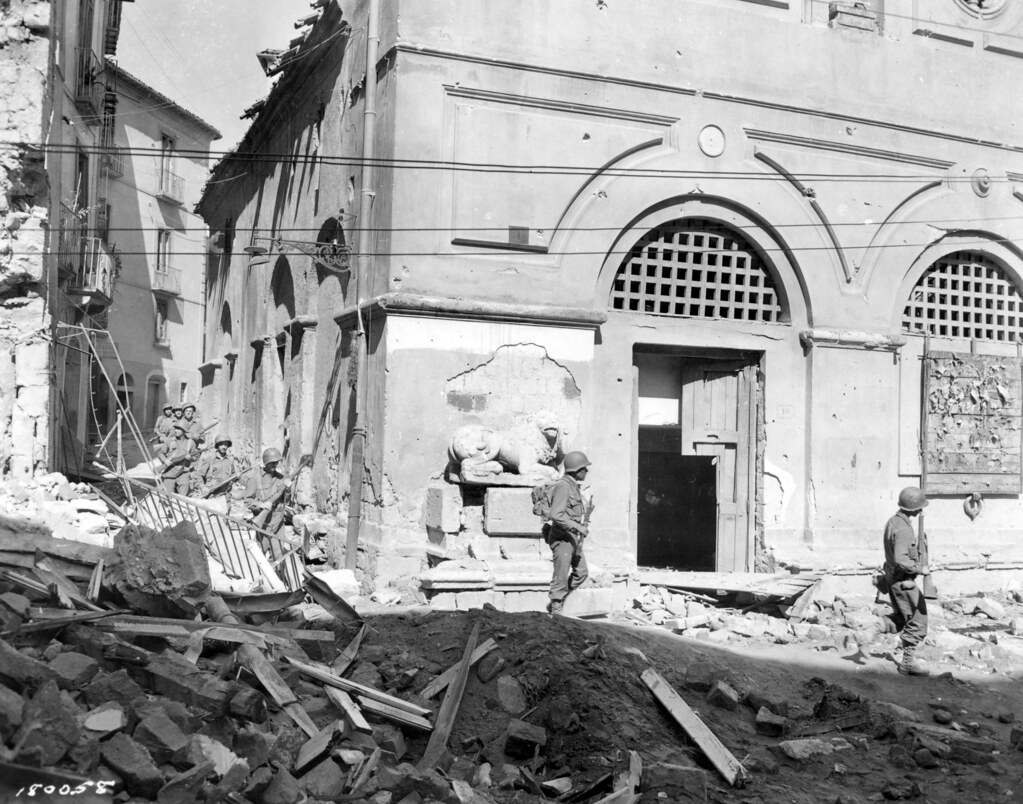 SC 180058 - American troops move into Avellino, Italy, over rubble and wreckage, past ruined buildings. 1 October, 1943.