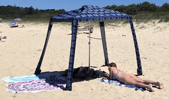 Why do they lie in the sun on a beach with a phone?