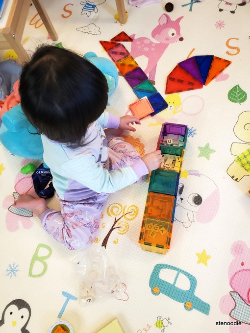 Toddler playing with magnetic tiles