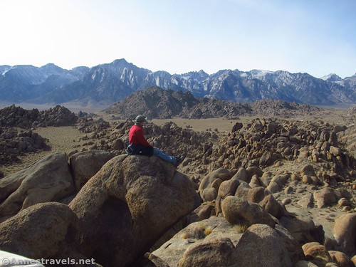 Sitting on a rock high above the Alabama Hills with Lone Pine Peak and Mt. Whitney in the Sierras beyond, California
