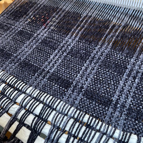 I’d like to sing you a song called “Weaving is so much faster than knitting.” ⚡️ (Plaid wrap, @TessYarns Silk Chenille in grey and black, woven on a 20” @Schacht_Spindle_Company Flip Loom) ⚡️ #WeaversOfInstagram #Handwoven #BIPOCMaker #Weaving #ha