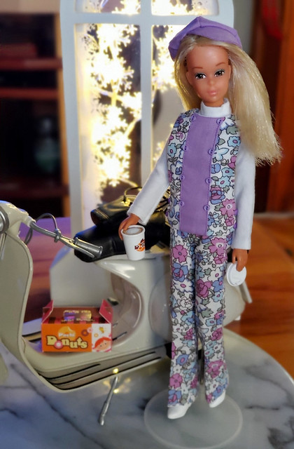 Baggie Casey is celebrating the New Year by treating herself to coffee and donuts.  She is wearing a FAB outfit, which was a gift from DuDidier.  Such a wonderful outfit and SO cute on her. As well, it is a 3-piece, with a great white turtleneck top.
