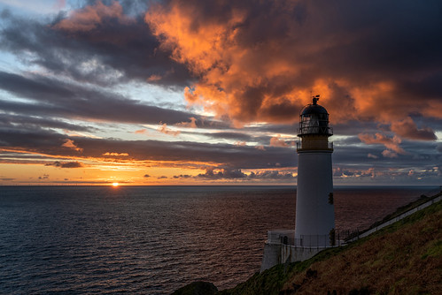 Torch by James Brew (www.jamesbrew.com), The clouds above Maughold Head Lighthouse catch fire as they reflect the first rays of light after t