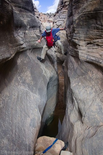 Chimneying across the puddle.  You can see the webbing at the bottom of the photo.  Baptist Draw, San Rafael Swell, Utah