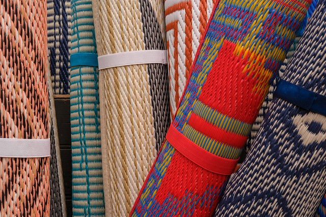 Rolled up woven rugs at Flowerland